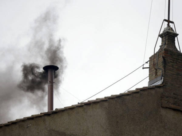 Black smoke emerges from the chimney on the roof of the Sistine Chapel, in St. Peter's Square at the Vatican, Wednesday, March 13, 2013. The black smoke indicates that the new pope has not been elected yet. (AP Photo/Gregorio Borgia)
